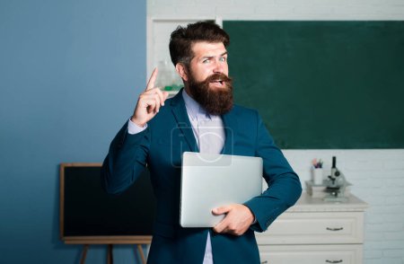 Photo for Teacher man with laptop notebook having idea. Amazed teacher waiting for students, smiling confidently. Positive expression emotions funny face - Royalty Free Image
