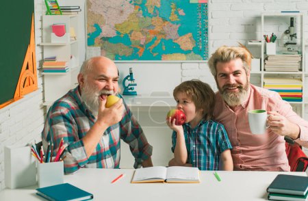 Photo for Fathers day. Happy smiling grandson boy with dad and granddad learning together at school. Happy family. Three men generation, grandfather father and son - Royalty Free Image