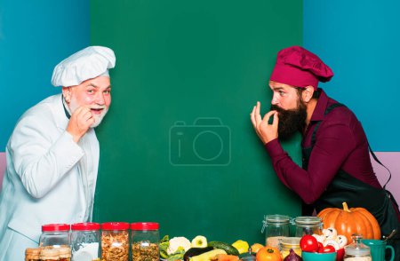 Photo for Two smiling male chefs, cooks or bakers with menu blank board. Perfect hand sign - Royalty Free Image