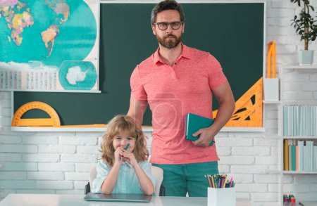 Photo for School pupil with teacher in classroom. Teacher helping child student pupil from elementary school in classroom - Royalty Free Image
