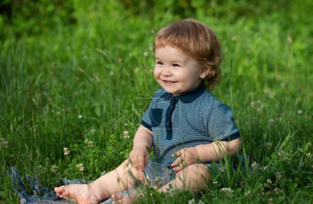 Photo for Children on pirnic. Cute baby on green grass in summertime. Funny little kid on nature. Happy Childhood - Royalty Free Image