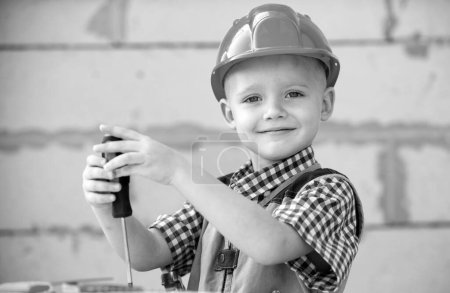 Photo for Child in building helmet, hard hat. Child dressed as a workman builder. Portrait happy smiling little builder in hardhats. Little builder in helmet - Royalty Free Image