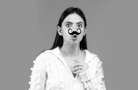 Photo for Crazy emotions. Just having fun. Woman holding fake mustache on her face. Suprised girl with moustache on stick - Royalty Free Image