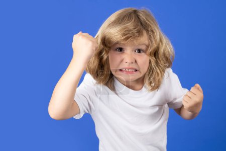 Photo for Kid boy with angry expression. Angry hateful little boy, child furious. Angry rage kids face. Anger child with furious negative emotion portrait. Aggressive and mad kid angry behavior - Royalty Free Image