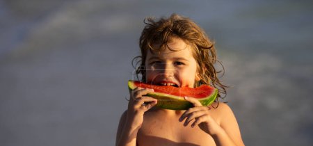 Photo for Child with watermelon on summer beach outdoor. Kid having fun in summer day. Kids summer vacation and healthy eating. Kittle kid eats juicy watermelon on the beach, coast, seashore. Summer fruits - Royalty Free Image