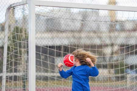 Photo for Child boy football or soccer player in action on soccer stadium kicking soccer ball for goal. Concept of sport, competition. Kid kick soccer ball. Kid kicking football ball. Sport for kids - Royalty Free Image