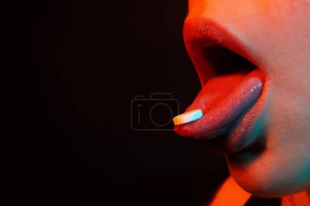 Photo for Pill on tongue close up. Woman taking pills, closeup. Sick ill woman holding antidepressant painkiller antibiotic pill. Take medicine. Female tongue with tablet pills. Lips holding pill in mouth - Royalty Free Image