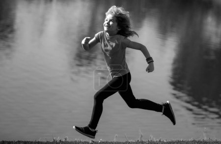 Photo for Child boy running outdoors. Kid running in a summer park. Outdoor sports and fitness for children, exercise outside - Royalty Free Image