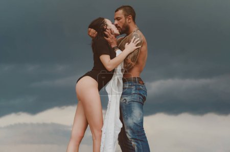 Photo for Muscular man and young female kissing. Beautiful young couple hugging. Love concept. Couple is hugging. Passion love couple. Romantic moment - Royalty Free Image