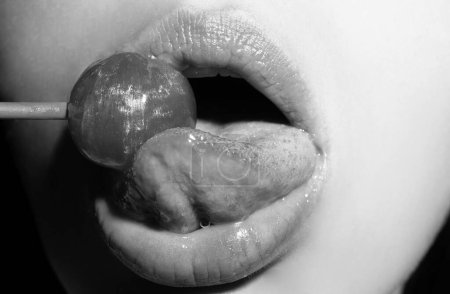 Licking tongue lips. Lips with candy, sexy sweet dreams. Oral sex blow job concept. Female mouth licks chupa chups, sucks lollipop
