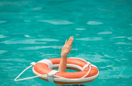 Photo for Drowning concept. No swimming. Rescue swimming ring in water. Safety water equipment - Royalty Free Image