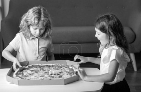 Photo for Hungry children eating pizza. Kids preparing to eat fresh pizza - Royalty Free Image