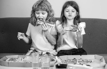 Photo for Children eating pizza. Little girl and boy eat pizza - Royalty Free Image