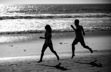 Téléchargez les photos : Couple running on beach. Sport runners jogging on beach working out. Fitness exercise outdoors concept - en image libre de droit