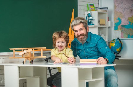 Photo for Elementary school tutor. Teacher and pupil in classroom. Pupil of primary school study indoors. Tutoring agency. Home study - Royalty Free Image