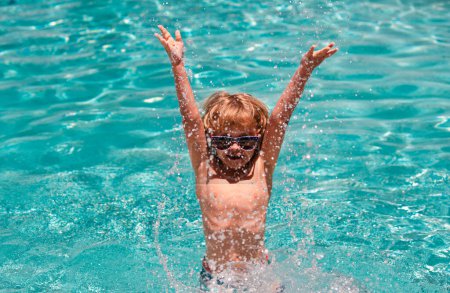 Photo for Excited child boy in sunglasses splashing in pool . Kid boy swim in swimming pool - Royalty Free Image