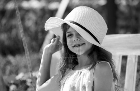 Téléchargez les photos : Adorable little girl portrait closeup outdoors in summer. Happy child relax in summer green background - en image libre de droit
