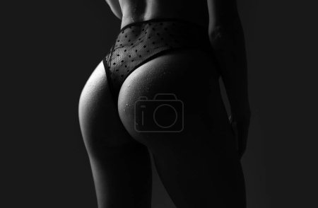 Foto de Sexy ass in erotic lingerie. Perfect Female Buttocks slim figure, bikini thong underwear. Woman sexy silhouette body in panties - Imagen libre de derechos