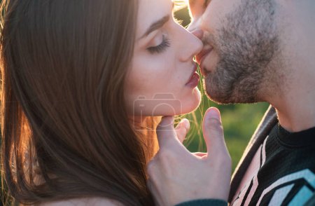 Sensual young sensual couple, man and woman, getting closer to kiss each other teasing enjoying tenderness and intimacy, feeling desire