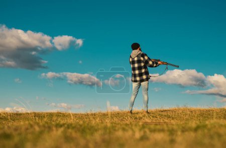 Photo for Hunter with shotgun gun on hunt. Illegal Hunting Poacher in the Forest. Hunting is the practice of killing or trapping animals - Royalty Free Image