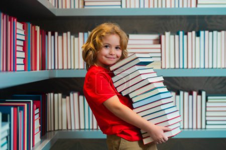 Photo for Back to school. Kid reads books in the library. Schoolboy with book in school library. Literature for reading. Child learning from books. School education and clever talented pupil genius - Royalty Free Image
