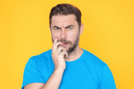 Photo for Handsome man standing over yellow background with hand on chin thinking about question. Pensive expression. Thoughtful face. Doubt concept. Thinking question, thoughtful about confusing idea - Royalty Free Image
