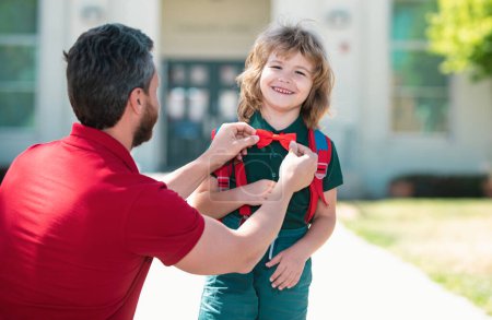 Photo for Funny nerd. Father supports and motivates son. Kid going to primary school. Kids education. Smart wunderkind in school uniform ready to school - Royalty Free Image
