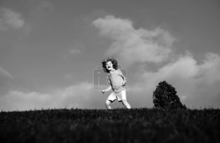 Photo for Little boy having fun at the park. Kid enjoy nature, childhood concept - Royalty Free Image