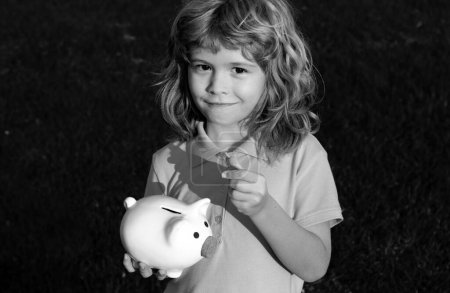 Photo for Portrait of cute little boy with piggy bank. Saving money concept. Kids with piggybank money box - Royalty Free Image