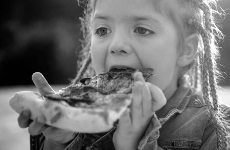 Photo for Kids favorite food. Tasty pizza. Child eating pizza. Fastfood. Italian junkfood. Little girl lunch outdoor - Royalty Free Image