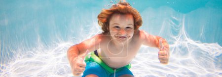 Photo for Child swim and dive underwater in the swimming pool. Kids holidays and summer vacation concept - Royalty Free Image