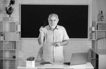 Photo for Portrait of confident caucasian senior teacher in classroom. Middle aged man professor at high school. Teachers day - Royalty Free Image