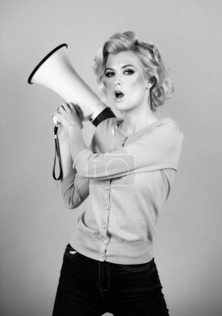 Woman girl posing on isolated background studio with megaphone. Screaming in megaphone. Idea for marketing or sales
