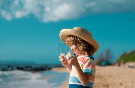 Photo for Portrait of a cute child boy in straw hat. Close up caucasian kids face. Closeup head of funny kid on summer beach - Royalty Free Image