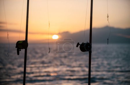 Fishing rods over a beautiful seascape. Sanset on sea