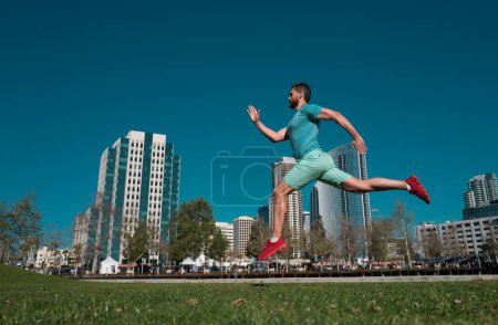 Photo for Sporty man runner running in summer. Dynamic jumping movement - Royalty Free Image