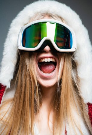 Photo for Excited woman in ski goggles. Close up winter portrait of young amazing girl with snow goggles - Royalty Free Image