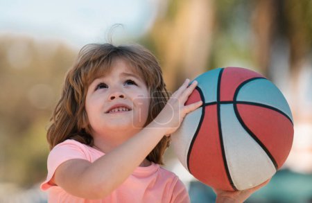 Child boy face preparing for basketball shooting. Best sport for kids