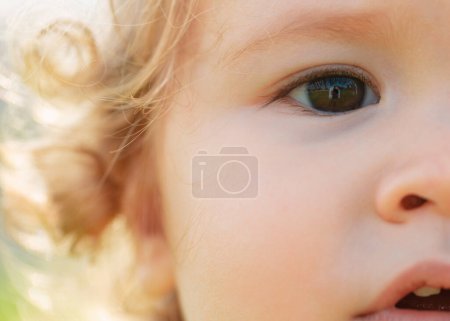 Téléchargez les photos : Portrait of a cute child baby. Close up caucasian kids macro cropped face. Closeup head of funny kid - en image libre de droit