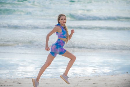 Photo for Running sexy woman jogging on beach. Fit woman doing workout on sea sand summer beach. Summer sport. Fitness female sport model jog lifestyle. The Running. Fit girl run on beach - Royalty Free Image