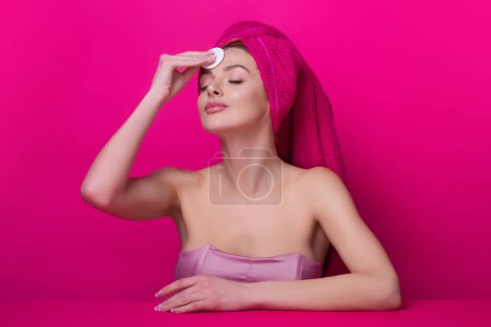Photo for Woman with cotton pad. Toner for cleaning make up. Clean healthy skin, studio background. Beauty woman holding cotton pad, applying cleansing lotion facial wipe on face, removing makeup - Royalty Free Image