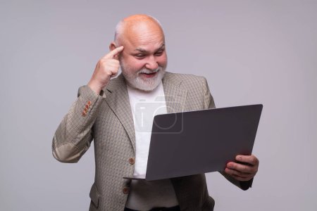 Photo for Older man hold laptop computer. Old age using laptop pc isolated on gray studio background. Mature man connected on laptop. Senior business man working on laptop. Teacher gray haired Professor - Royalty Free Image