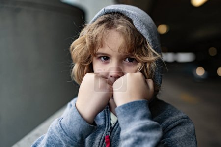 Photo for Aggressive child. Aggression kid boy fighting on street. Angry Aggressive kid with fist. Aggressive fight kid. Bullied, physical abuse, children fighting. Aggressive little boy. Kids bad behavioral - Royalty Free Image