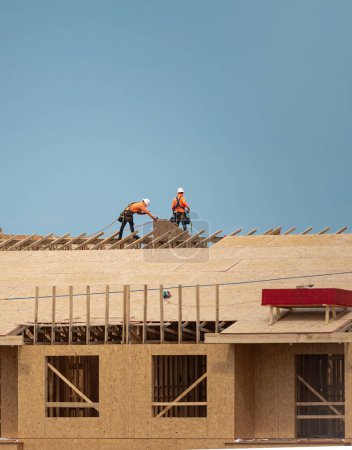 Photo for Roofer builder roofing on the roof structure - Royalty Free Image