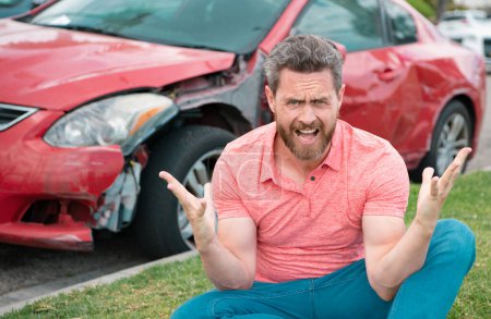 Photo for Stressed driver sitting on the road next to broken car - Royalty Free Image