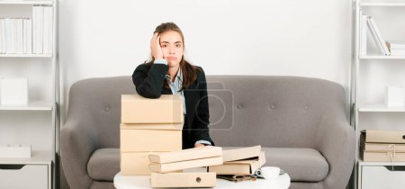 Sad busy secretary with folders with the documents, stressed overworked business woman too much work, office problem. Tired stressed employee at workspace