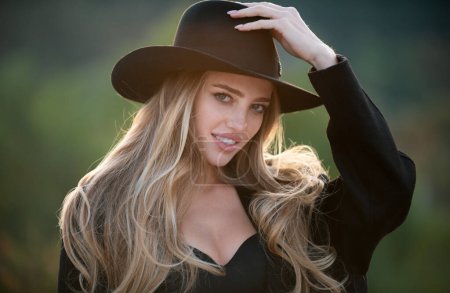 Photo for Portrait of young woman outdoor. Romantic girl in fashion brim black hat with beauty face - Royalty Free Image