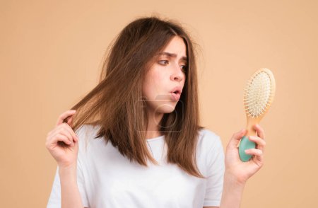 Foto de Mujer caída del cabello con un peine y cabello problemático. Concepto de pérdida de cabello y problemas calvos - Imagen libre de derechos