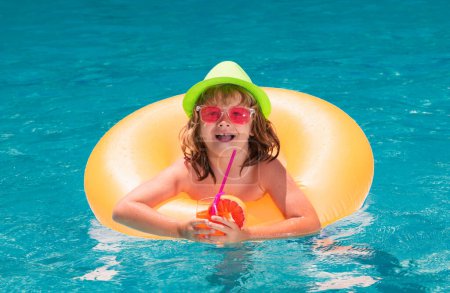 Photo for Boy kid in pool drinking cocktail. Happy lifestyle kids. Water toy, healthy outdoor activity for children. Kids beach fun. Child in swimming pool with inflatable toy ring - Royalty Free Image