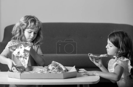Photo for Pizza and kids, slices pizza in kids hand. Children eating tasty fast food pizza with cheese. Little children friends, boy and girl bite pizza - Royalty Free Image